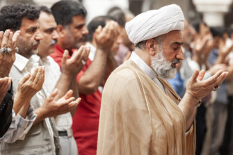 men_praying_holding_hands_up_muslims_photo_IMB