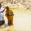 a_man_and_a_woman_in_river_getting_baptised_photo_by_IMB