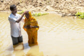 a_man_and_a_woman_in_river_getting_baptised_photo_by_IMB