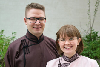 man_and_woman_smiling_in_traditional_Mongolian_costumes